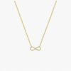 Gold infinity necklace on a white background