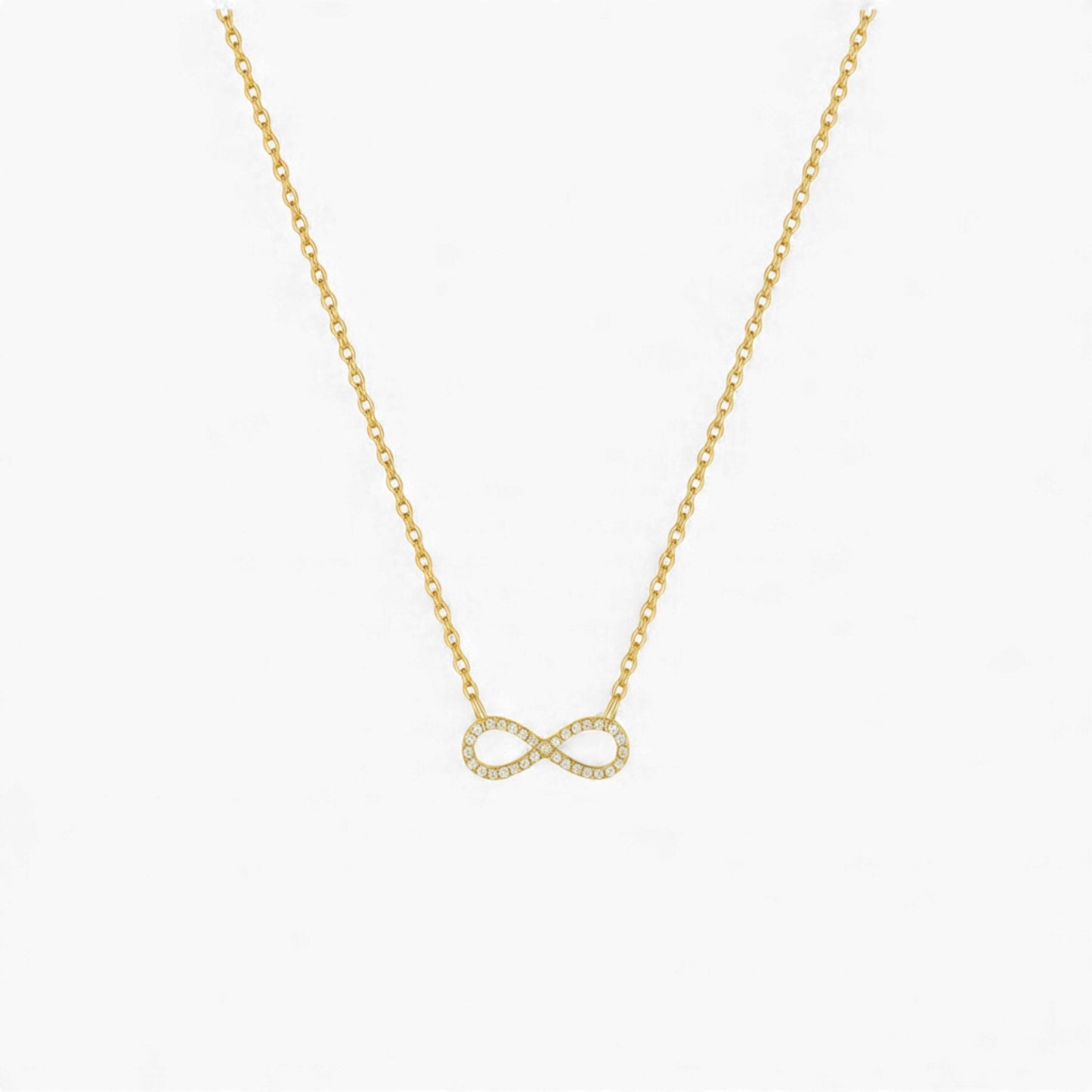 Gold infinity necklace on a white background