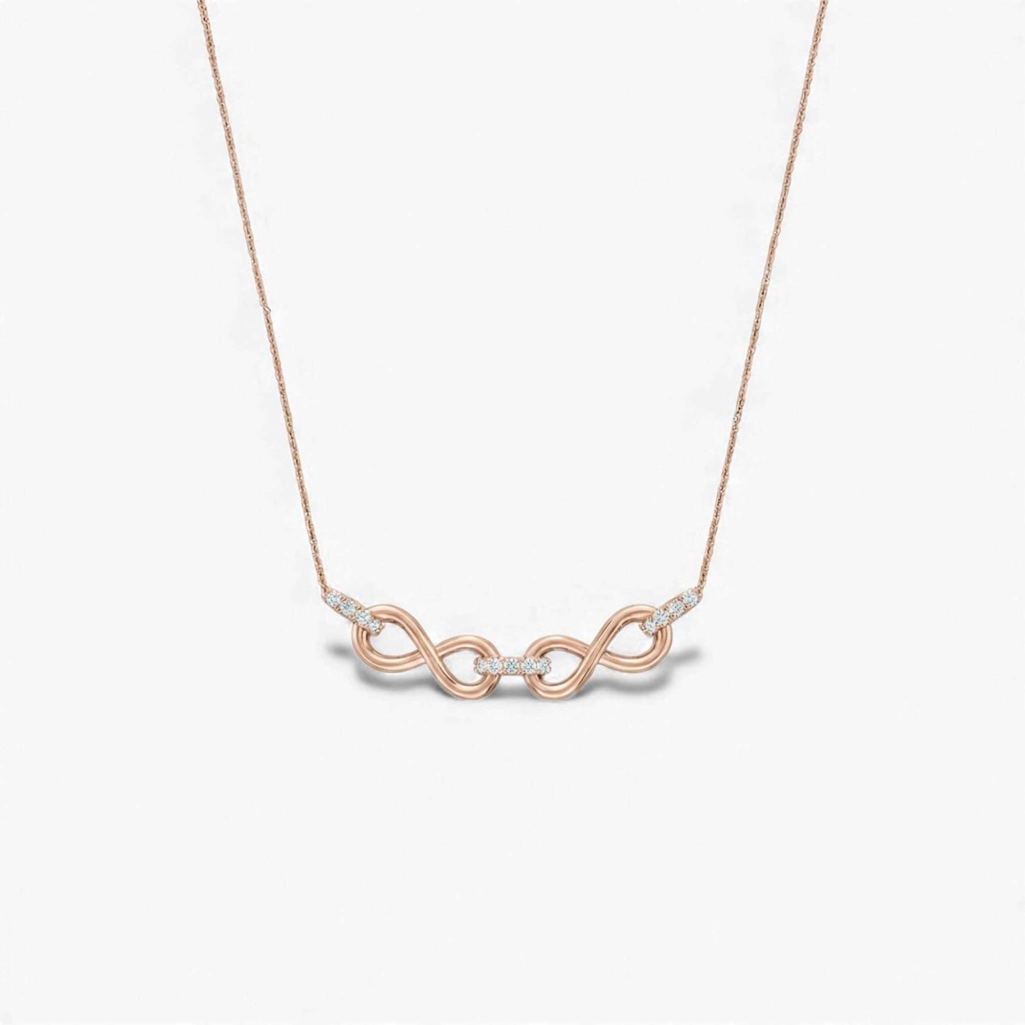 Rose gold necklace with a unique pendant on a light gray background