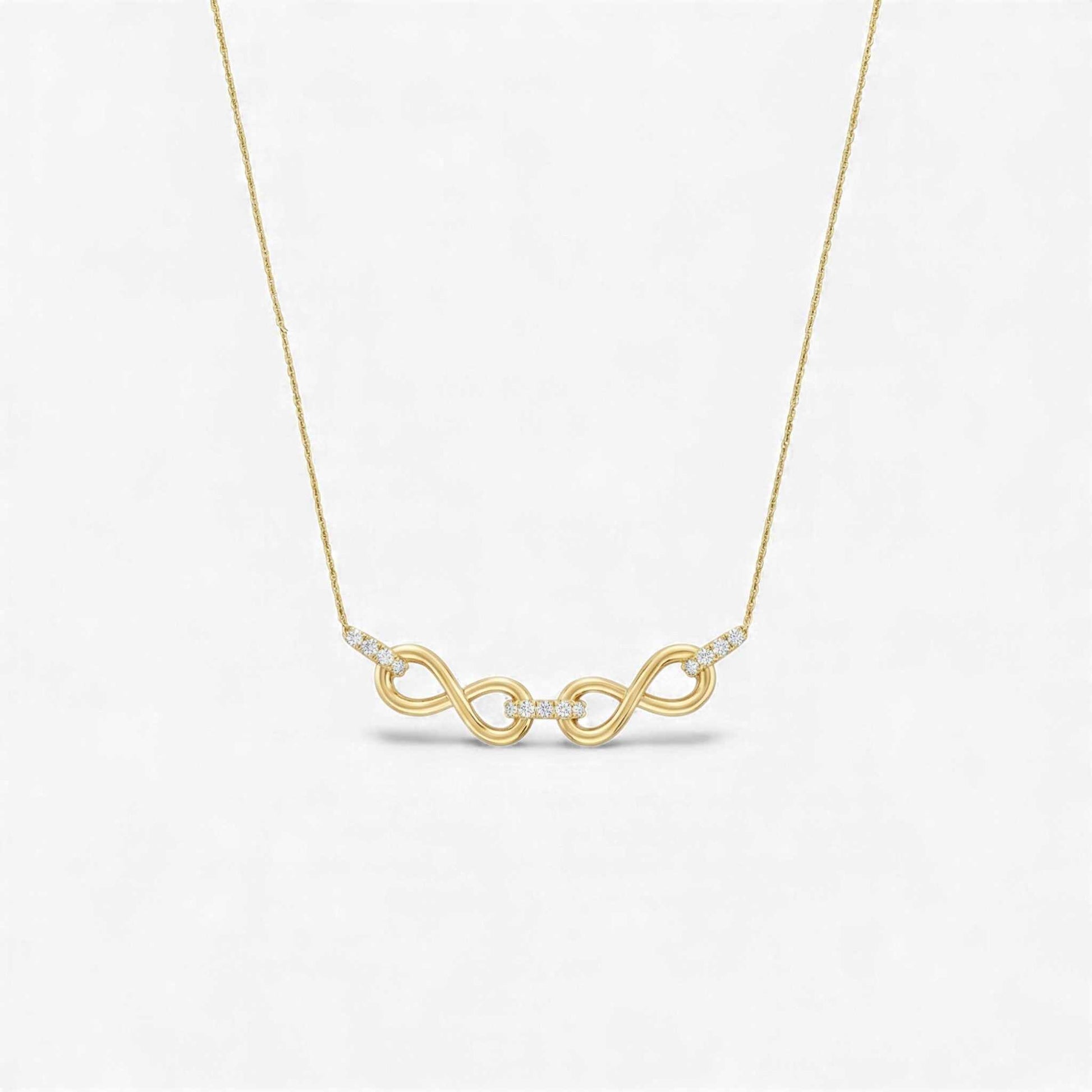 Gold necklace with a double infinity symbol pendant on a light gray background