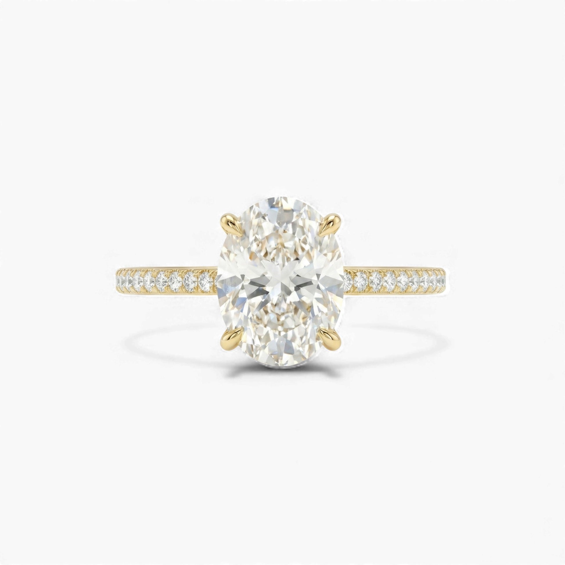 Gold ring with a large diamond and smaller diamonds on the band against a white background