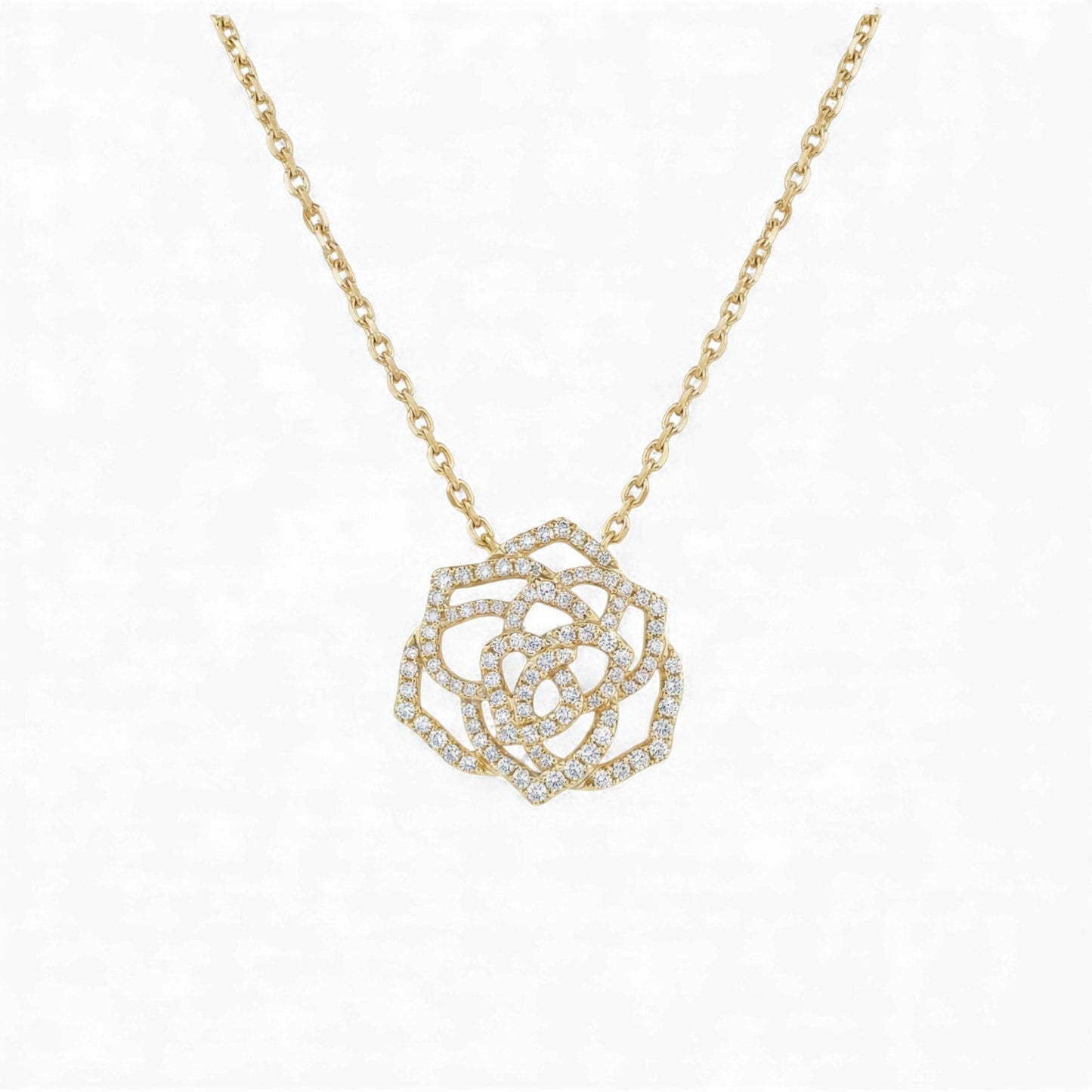 Gold necklace with a diamond-encrusted rose pendant on a white background