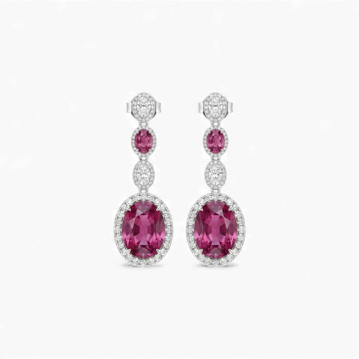 Pair of pink gemstone earrings with diamond accents on a white background