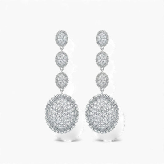 Pair of silver earrings with circular designs on a white background