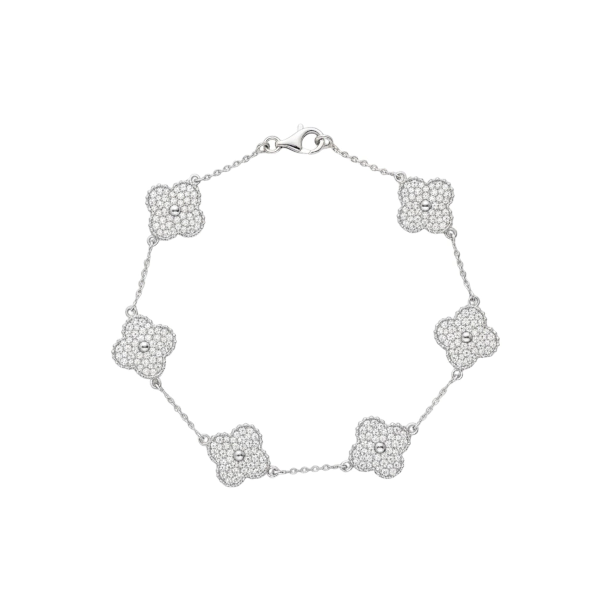 Silver bracelet with floral designs on a white background