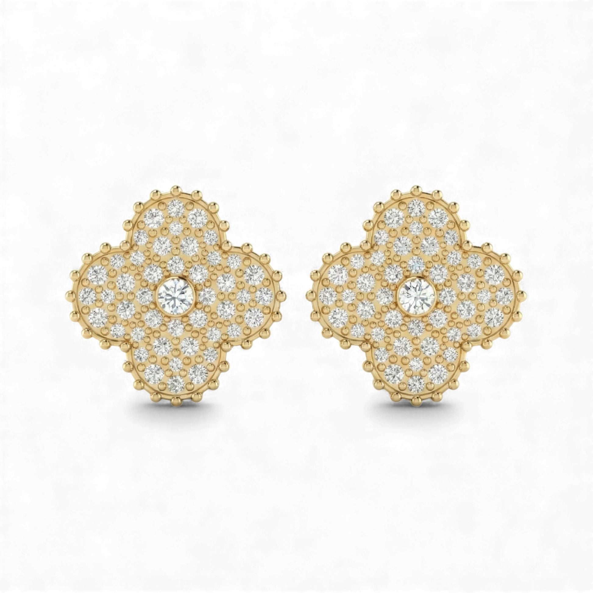 Gold earrings with diamond accents on a white background
