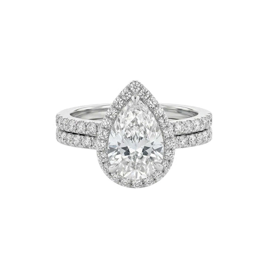 Diamond ring with a pear-shaped center stone on a white background