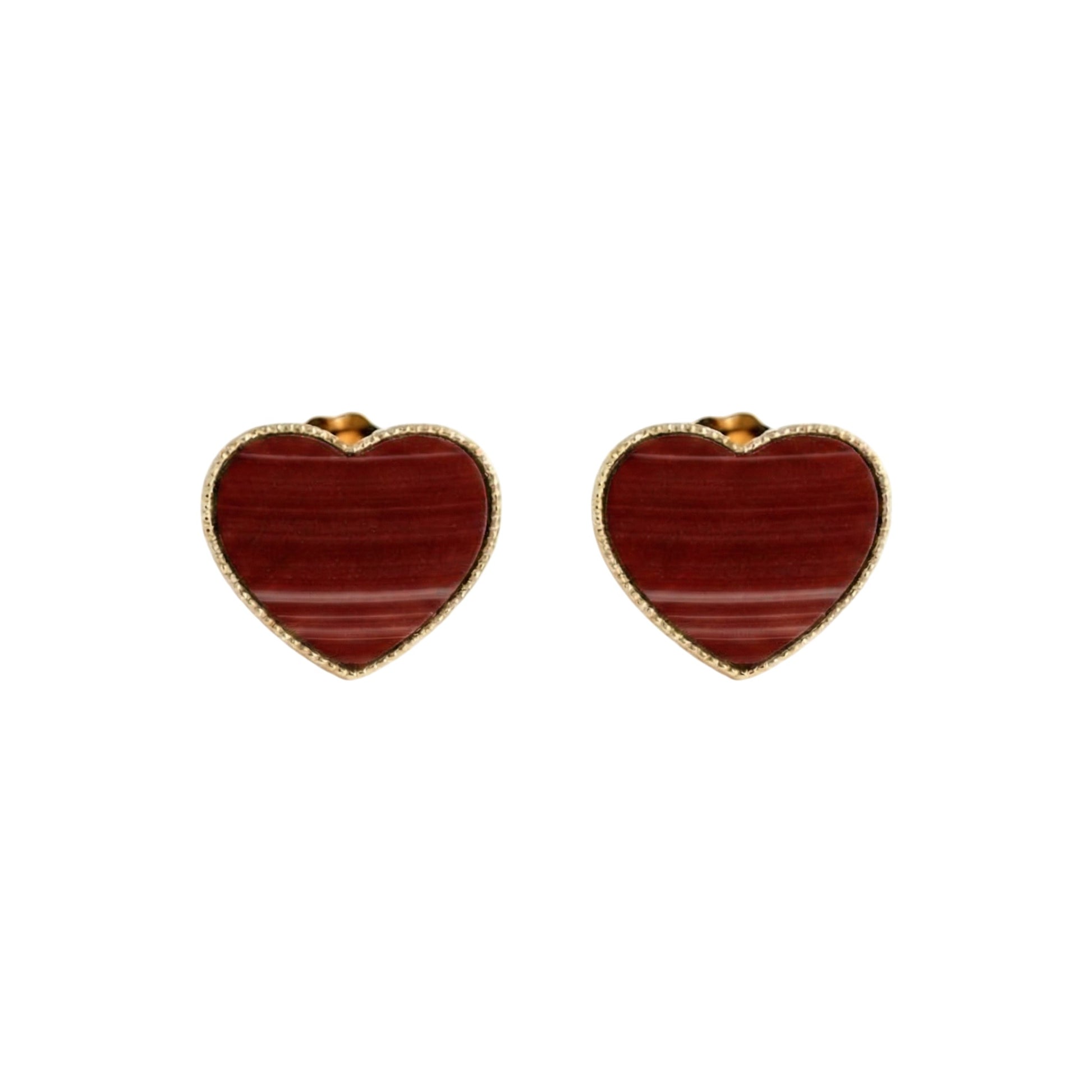 Heart-shaped earrings with red stone center on a white background