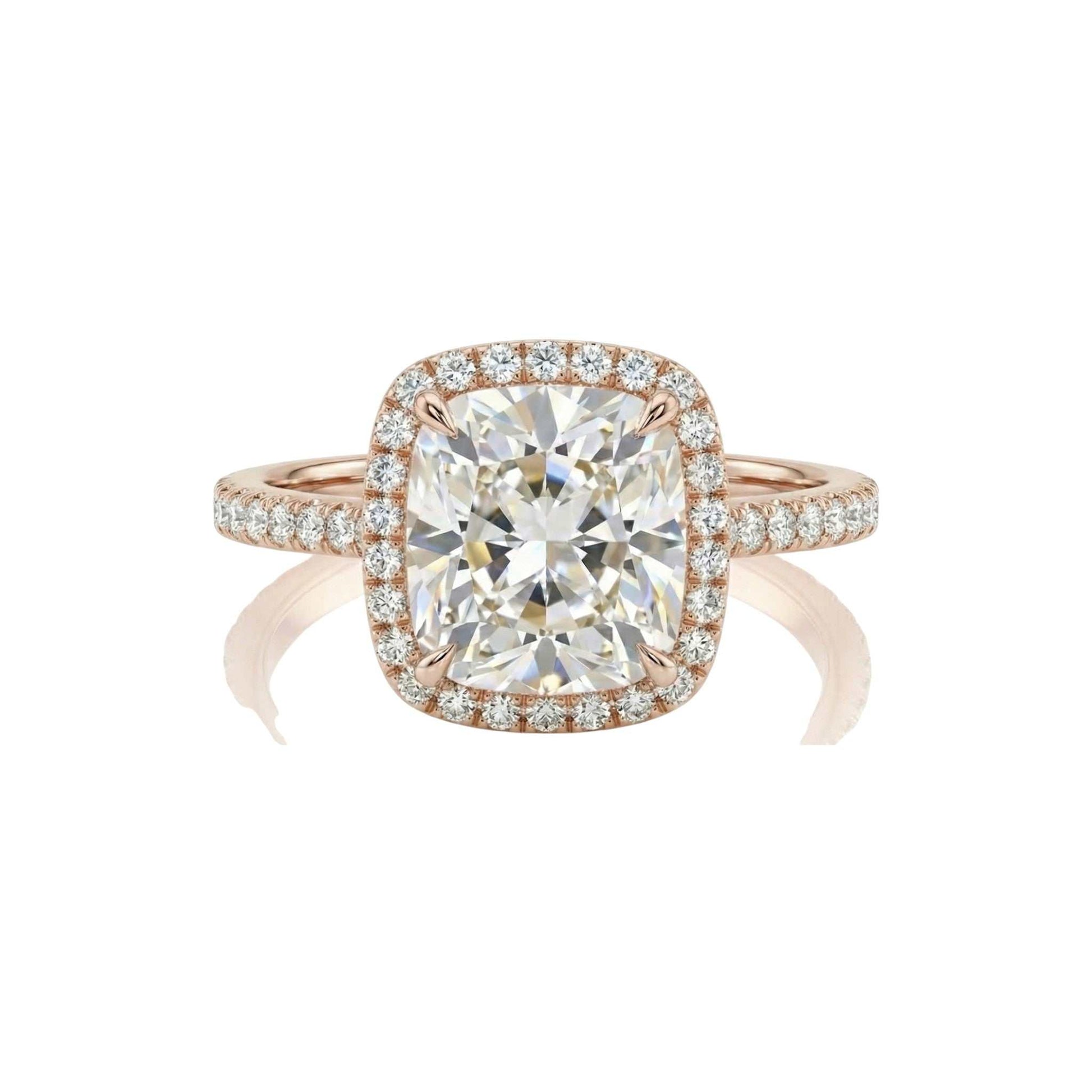 Rose gold ring with a large diamond and smaller diamonds on the band against a white background
