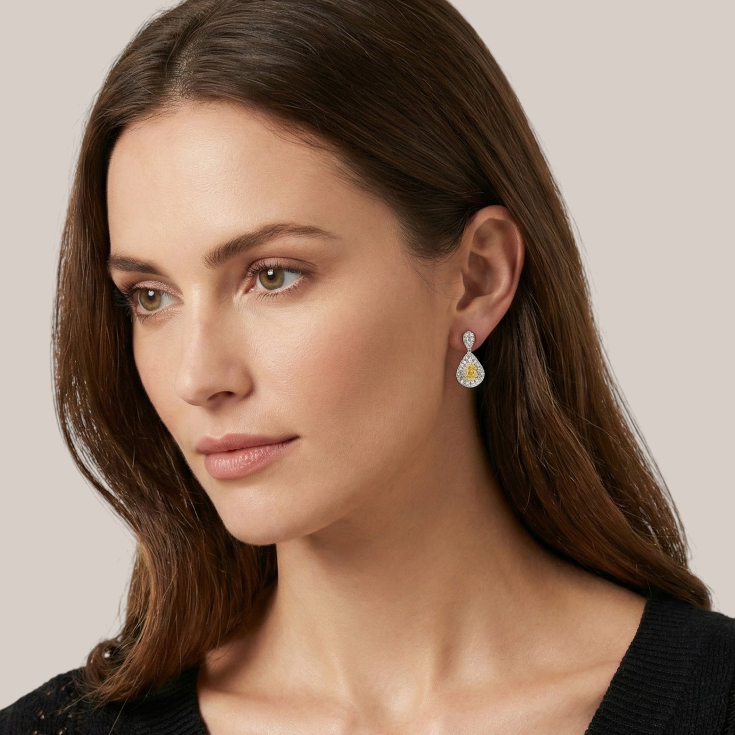 Close-up of a woman wearing earrings with a neutral background