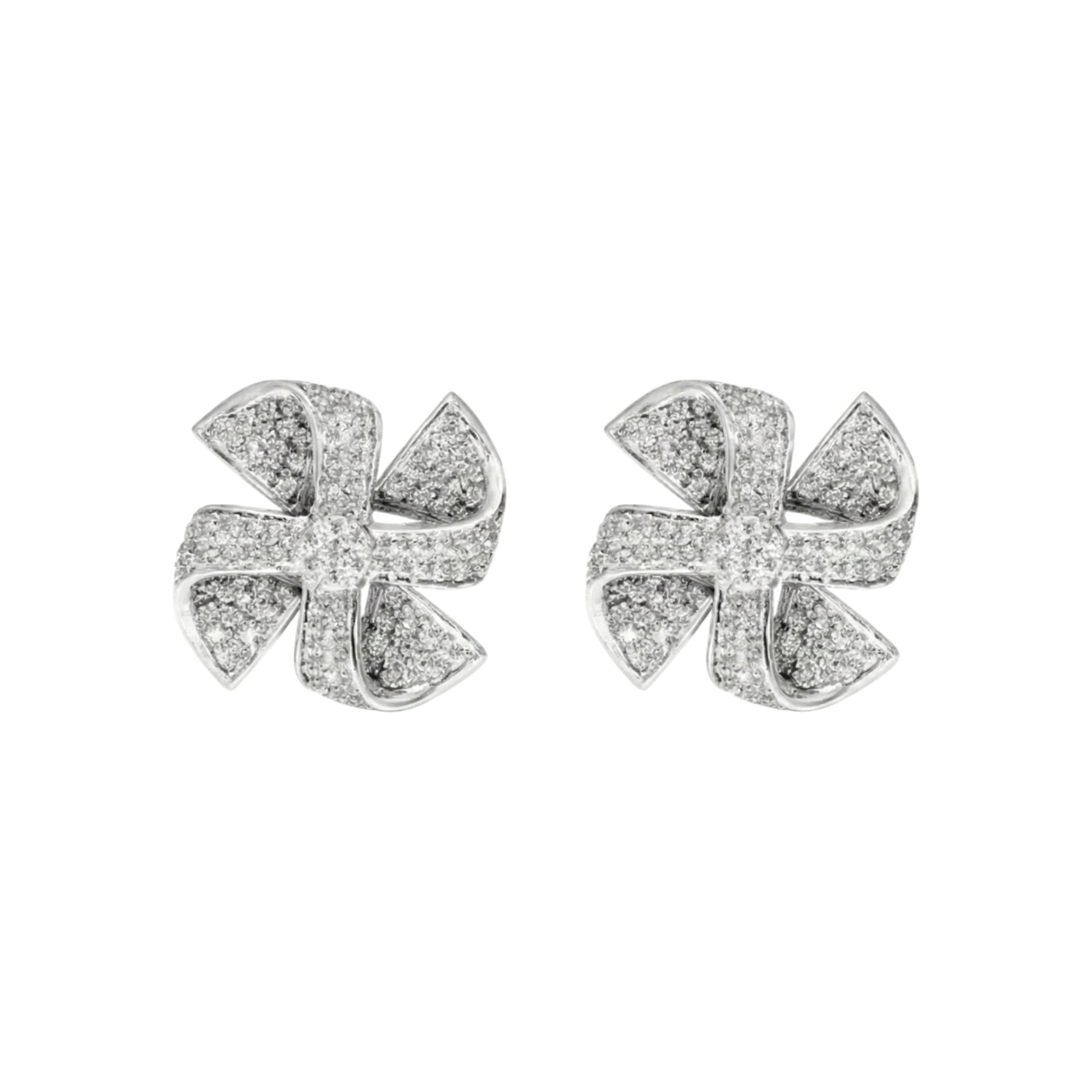 Pair of silver earrings with diamond-like stones on a white background