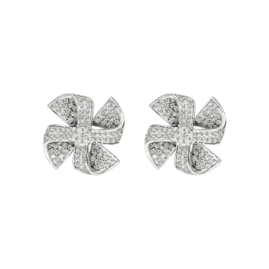 Pair of silver earrings with diamond-like stones on a white background