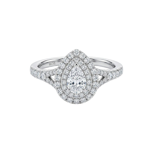 Diamond ring with a pear-shaped center stone on a white background