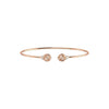 Rose gold bracelet with two spherical charms on a white background