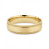 Gold ring with textured design on a white background