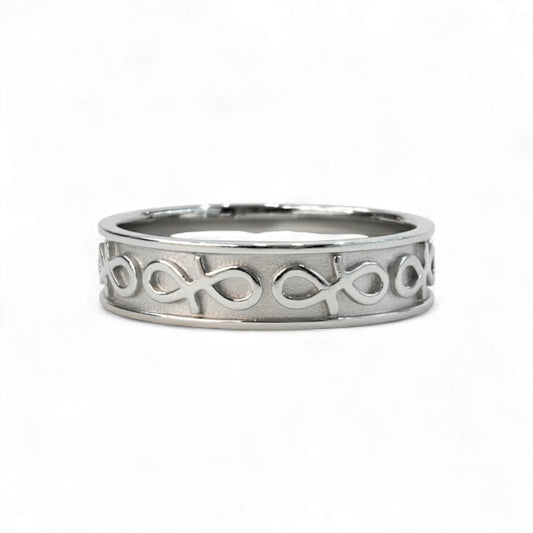 Silver ring with intricate design on a white background