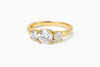 Gold ring with three diamonds on a white background