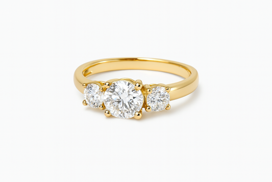Gold ring with three diamonds on a white background