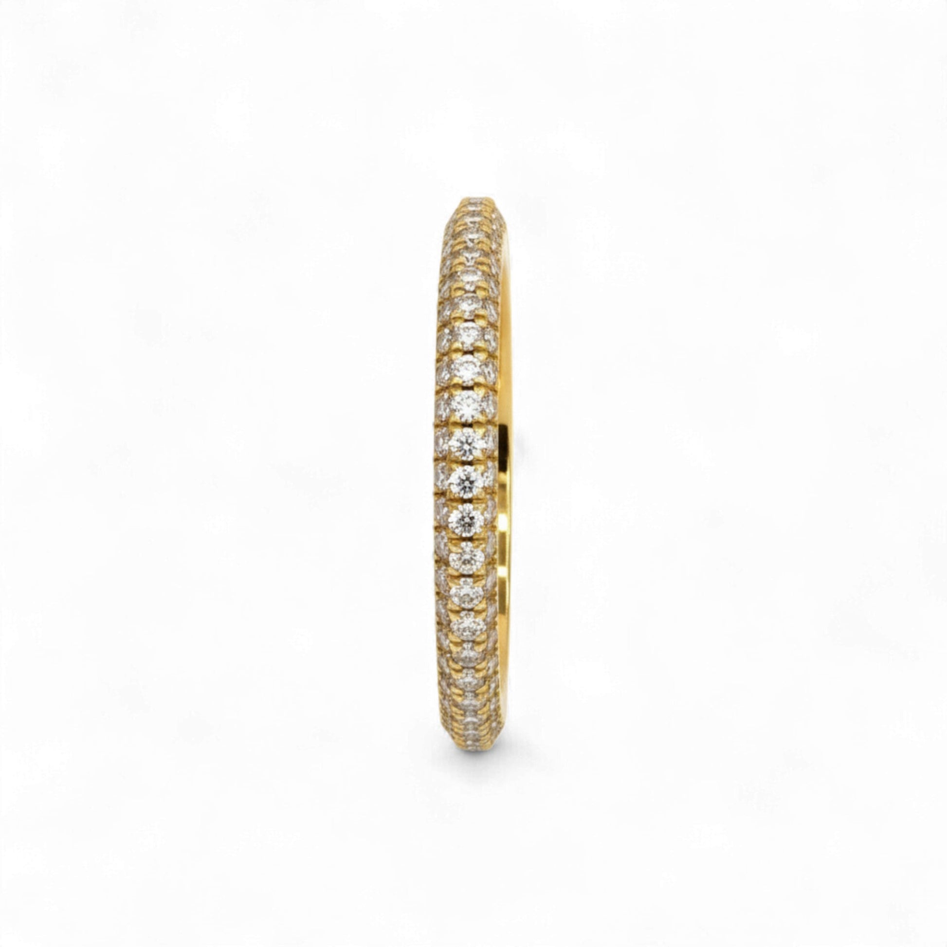 Gold ring with diamond accents on a white background