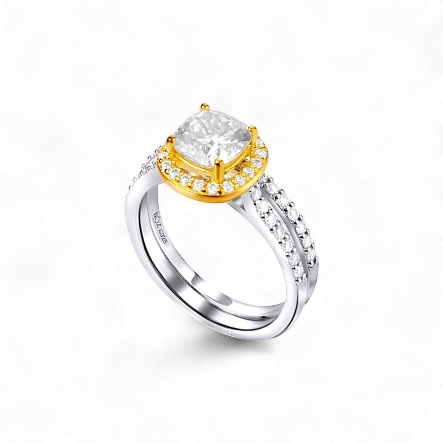 Two-tone ring with a large central gemstone and smaller stones on a white background