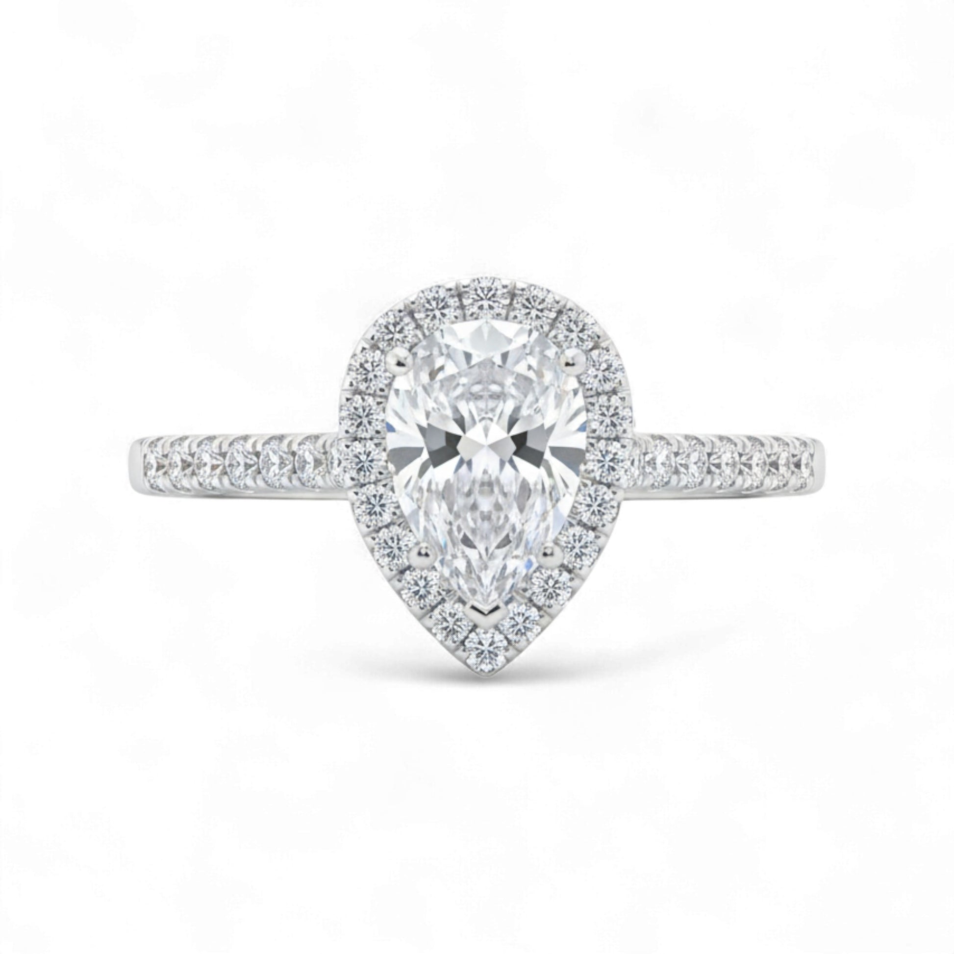 Diamond ring with pear-shaped center stone on a white background