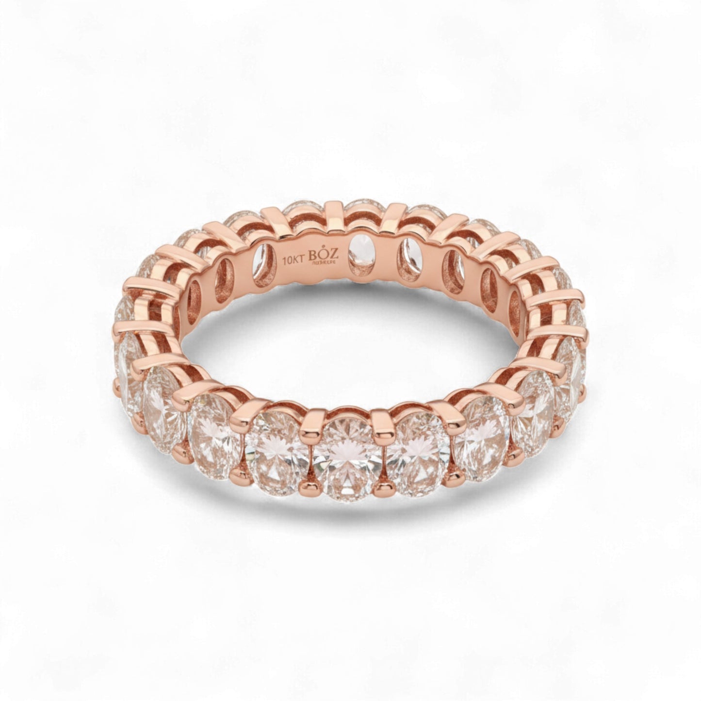 Rose gold ring with diamonds on a white background