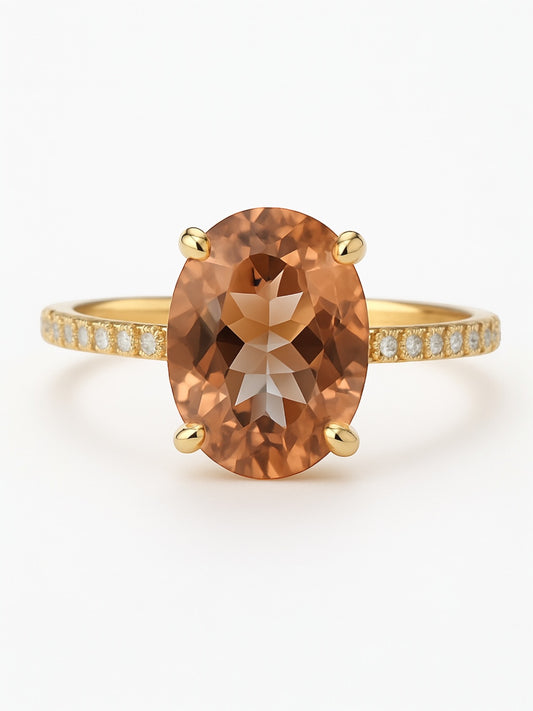 Gold ring with a large brown gemstone on a white background