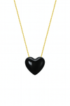 Black heart-shaped pendant on a gold chain against a white background