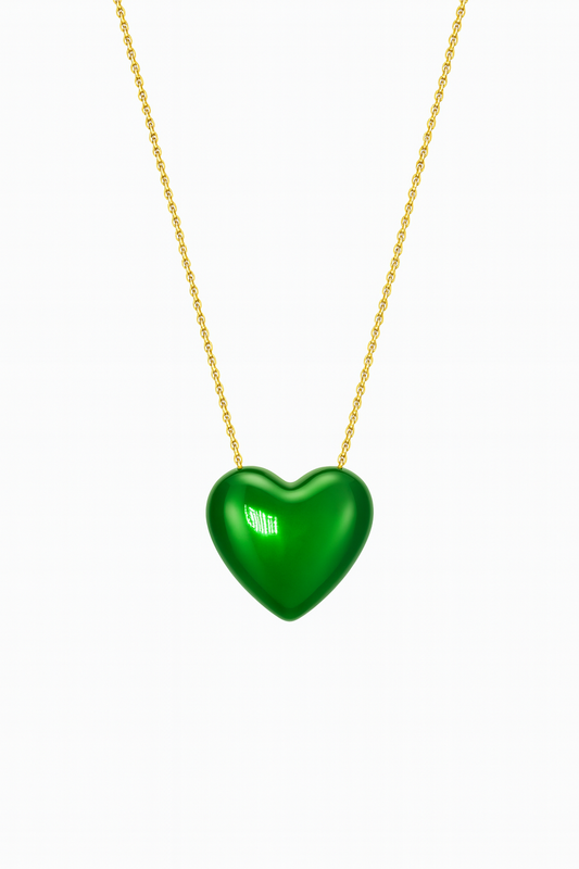 Green heart-shaped pendant on a gold chain against a white background