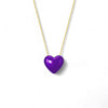 Purple heart-shaped pendant on a gold chain against a white background