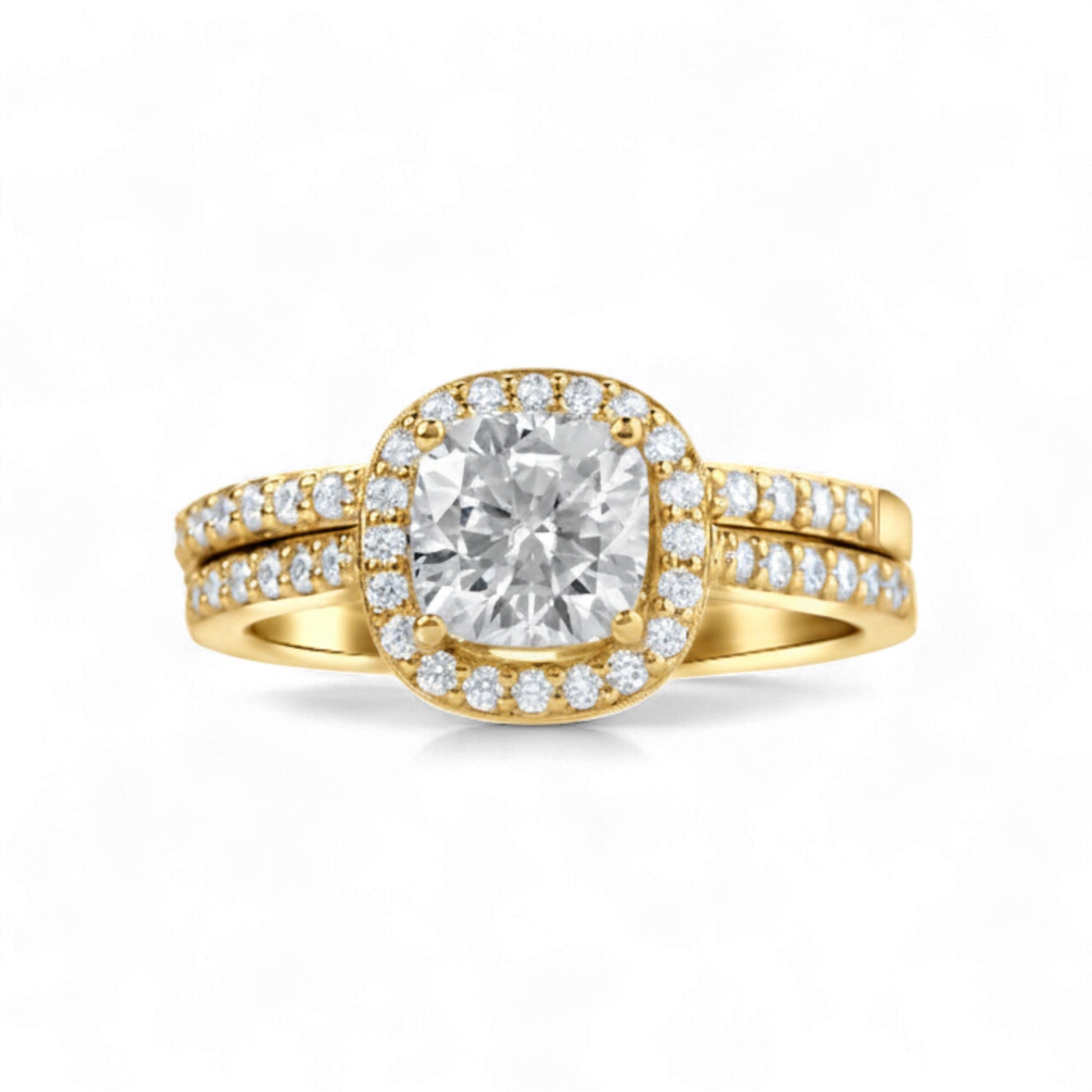 Gold ring with a large diamond and smaller diamonds on the band against a white background