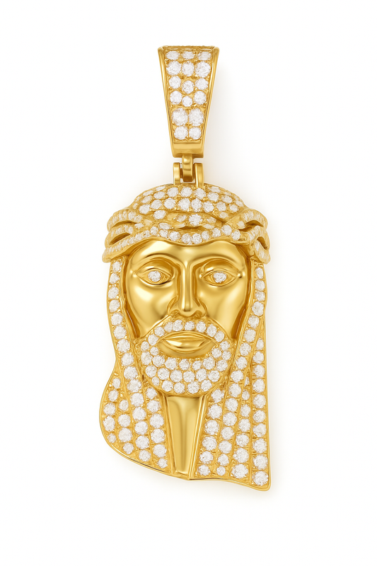 Gold pendant with face design and clear stones on a white background