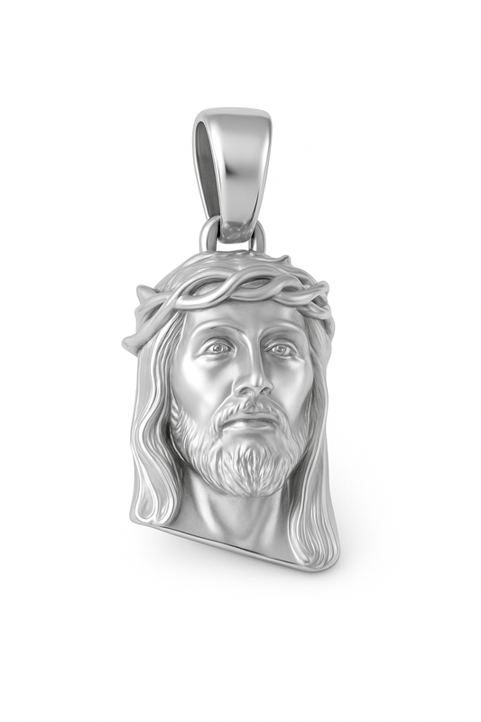 Silver pendant of a religious figure on a white background