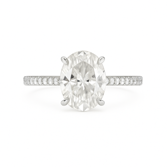 Diamond ring with a large central gemstone and smaller stones on the band against a white background