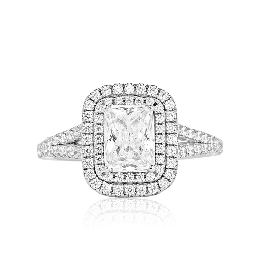 Diamond ring with a rectangular center stone on a white background