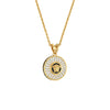 Gold necklace with a round pendant featuring a face design on a white background