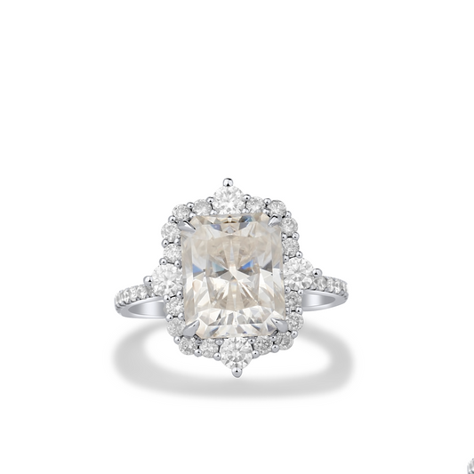 Diamond ring with a large central gemstone and smaller stones on a white background