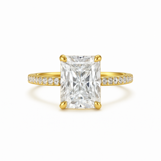 Gold ring with a large diamond and smaller diamonds on the band against a white background