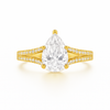 Gold ring with a pear-shaped diamond on a white background