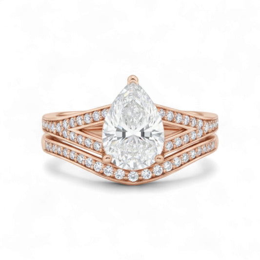 Rose gold ring with a pear-shaped diamond on a white background