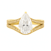 Gold ring with a large pear-shaped gemstone on a white background