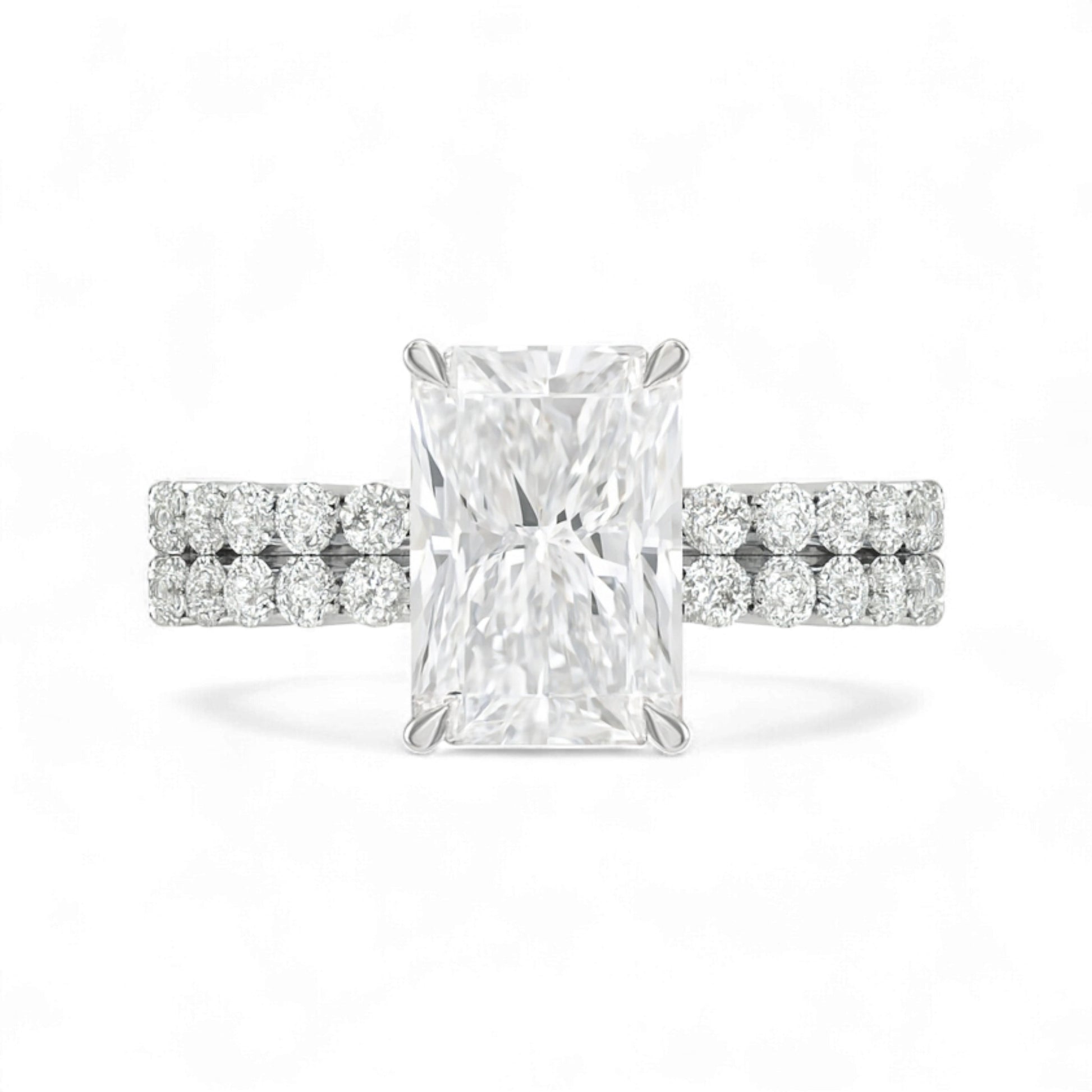 Diamond ring with a rectangular center stone on a white background