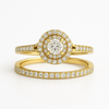 Gold ring with diamond accents on a white background
