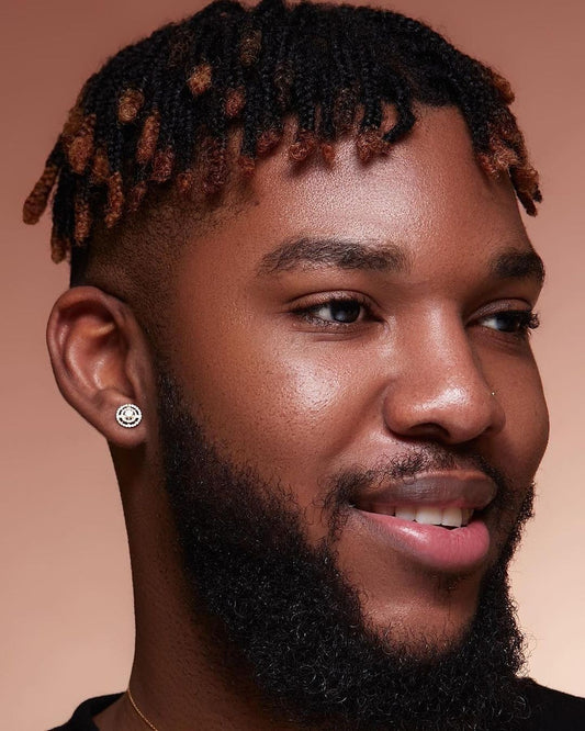 A person with a beard and earrings, showcasing the Orbit Diamond Stud Earrings.