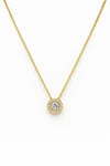Gold necklace with a diamond pendant on a white background