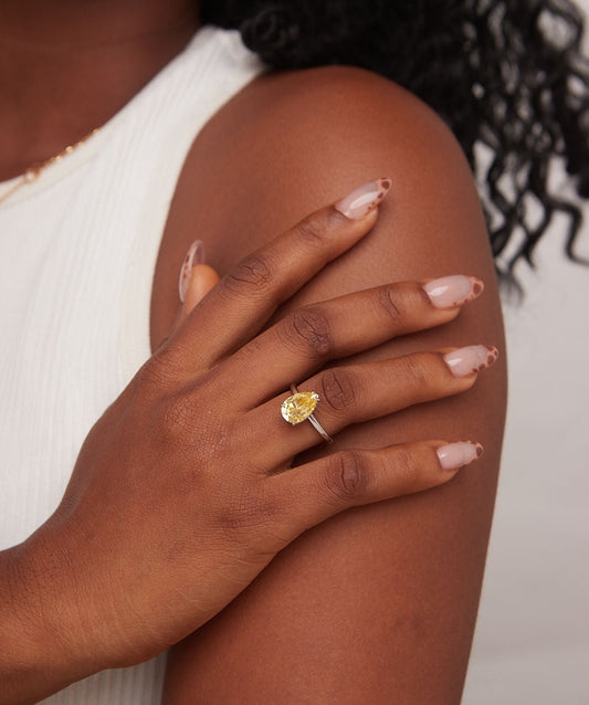 Hand with a yellow ring on a blurred background