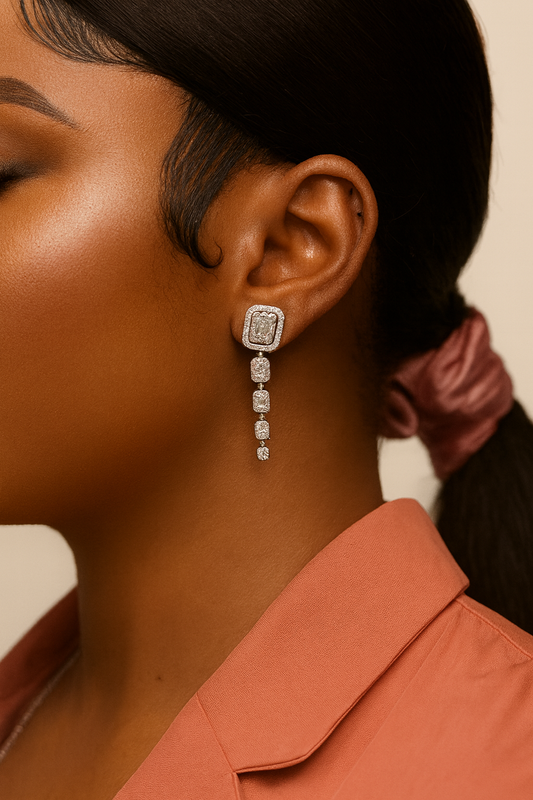 Close-up of a person wearing a diamond earring with a blurred background