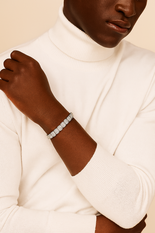 Person wearing a white turtleneck sweater with a bracelet on a beige background