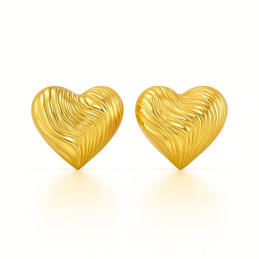 Gold heart-shaped earrings on a white background