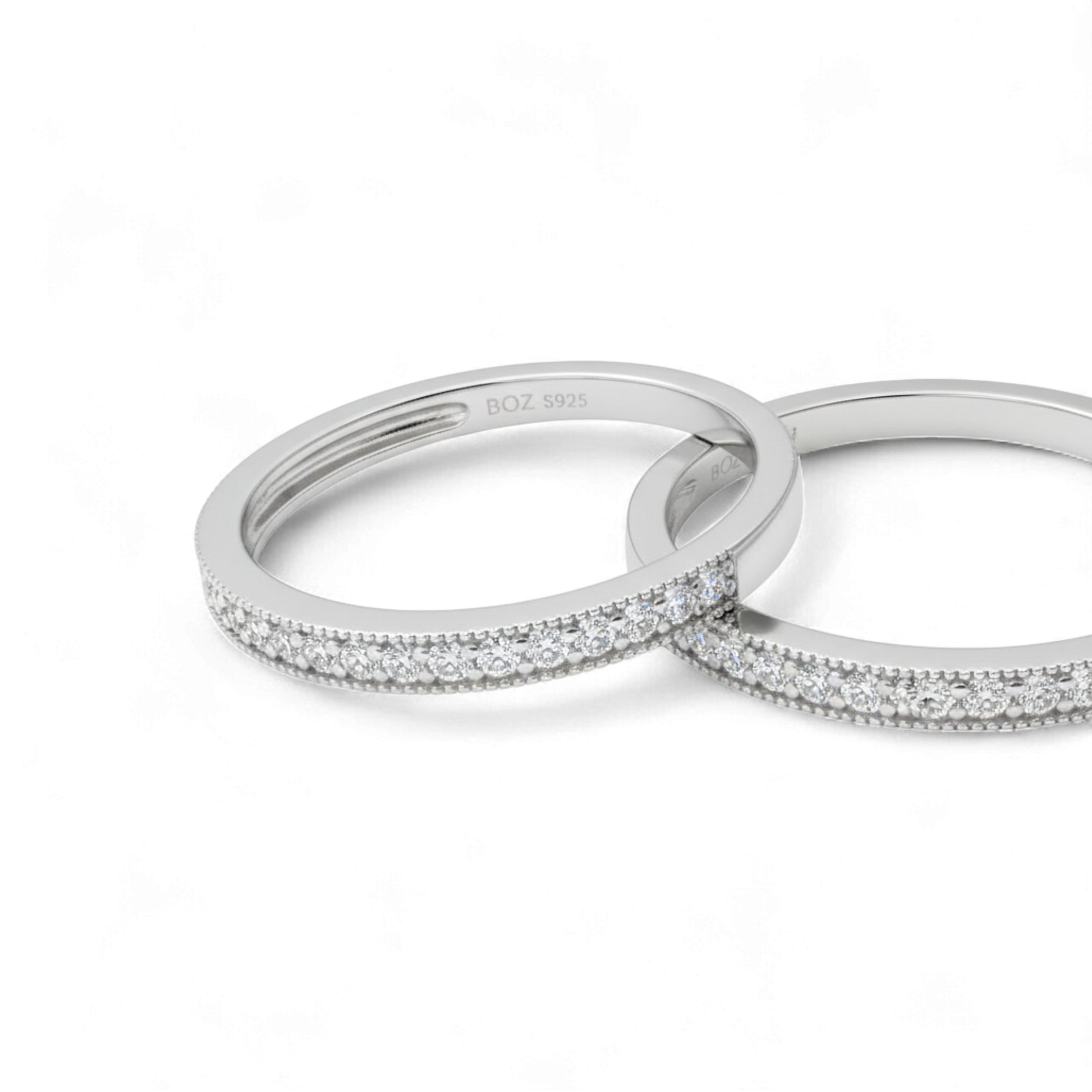 Two silver rings with diamond accents on a white background